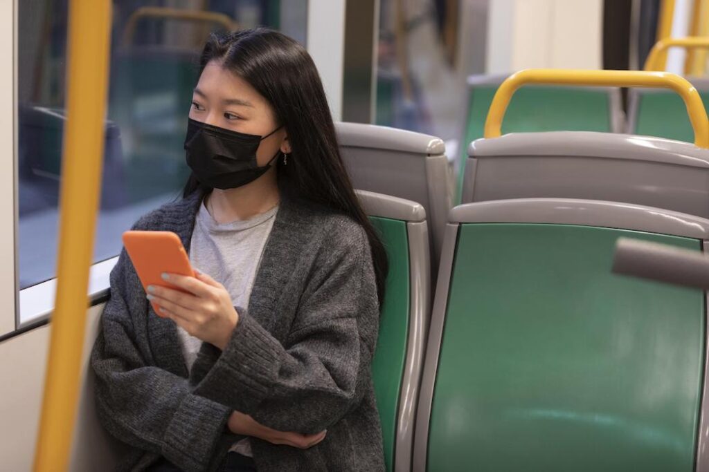young woman on a bus with mask